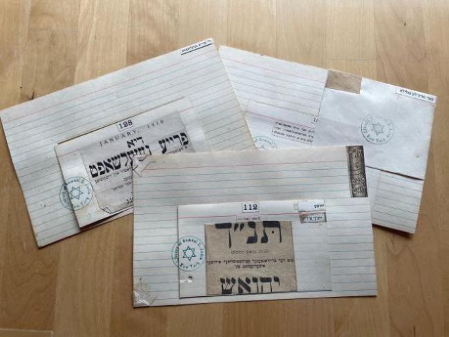Three handmade Yiddish cards on a table