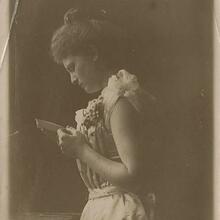 A young woman reading a letter