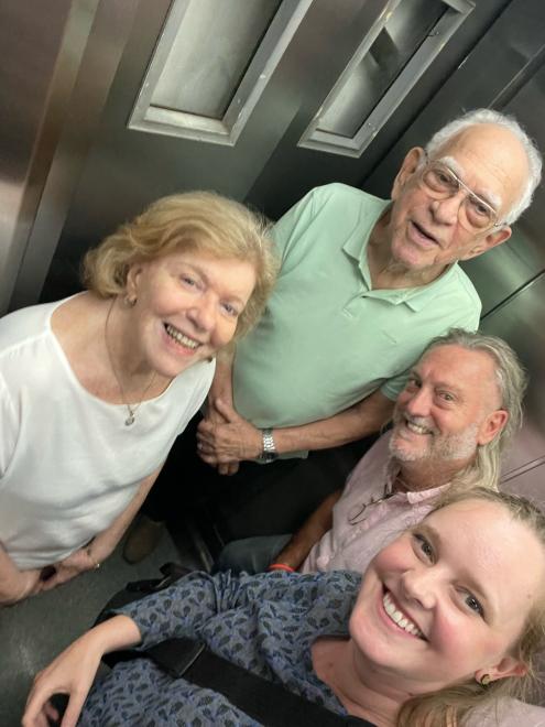 Christa Whitney and three others stand in an elevator after recording an oral history interview.