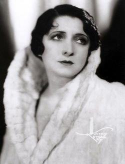 Jennie Goldstein wearing a coat and looking away from camera