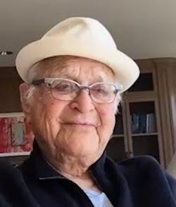 Norman Lear wearing glasses and a white fedora