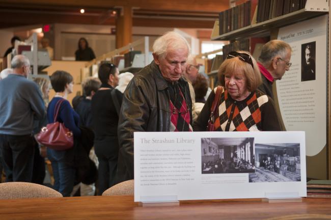 Visitors gather in Yiddish Book Center exhibit