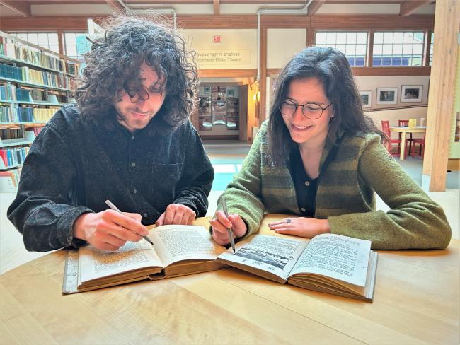 Bibliography fellows Charlotte and Joey doodle in their Yiddish books.