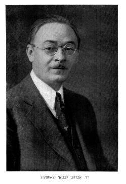 Black and white photo of a man with round glasses