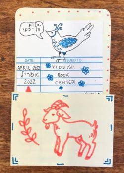 A paper book insert with a drawing of a bird and goat on the front
