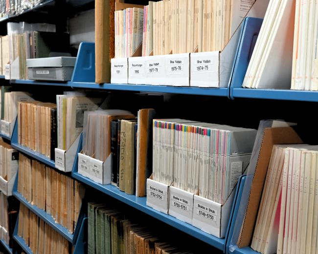 Colorful periodicals in labeled boxes on shelves