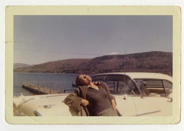 Blume soaks up the sun on a road trip to upstate New York, leaning against the family car, a 1957 Oldsmobile 98.jpg