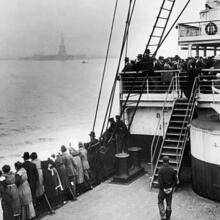 A ship approaches Ellis Island.