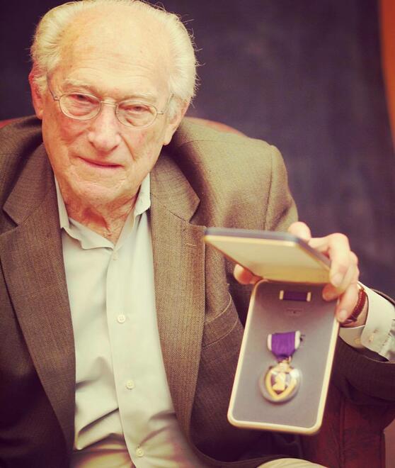 William Robin, z"l, showing his Purple Heart medal 