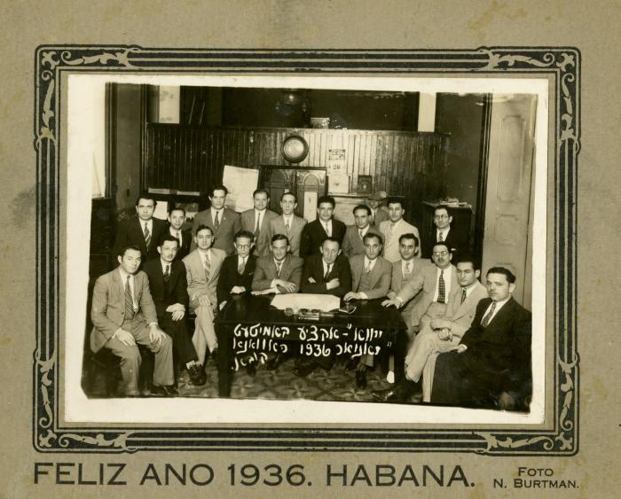 Men in suits pose for a picture with the caption in Yiddish YIVO Action Committee January 1936 Havana, Cuba