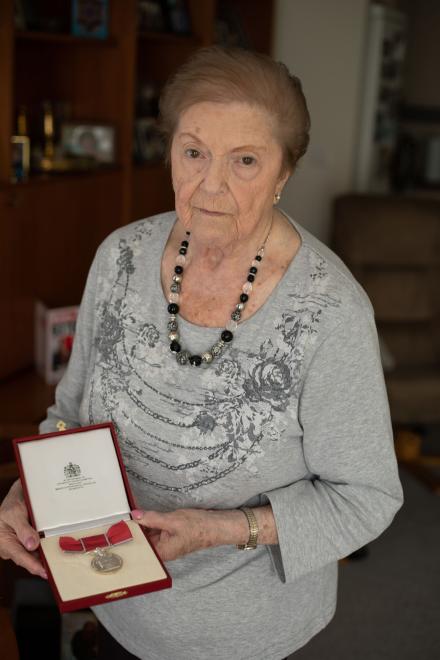 Rachel Levy holds the British Empire Medal she received from royal family.
