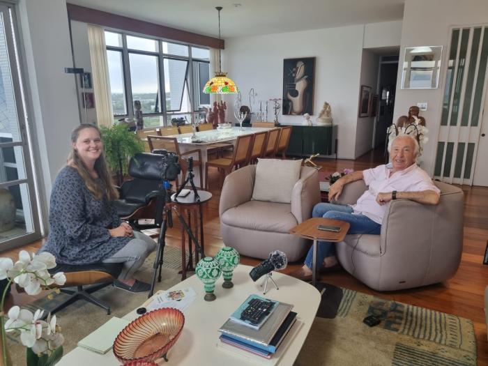 Christa Whitney sits with Alex Lomachinsky during an oral history interview in a living room 