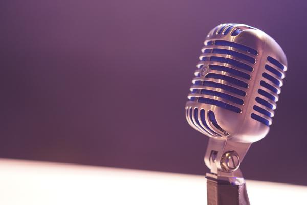 Old fashion radio microphone on a table with soft lighting