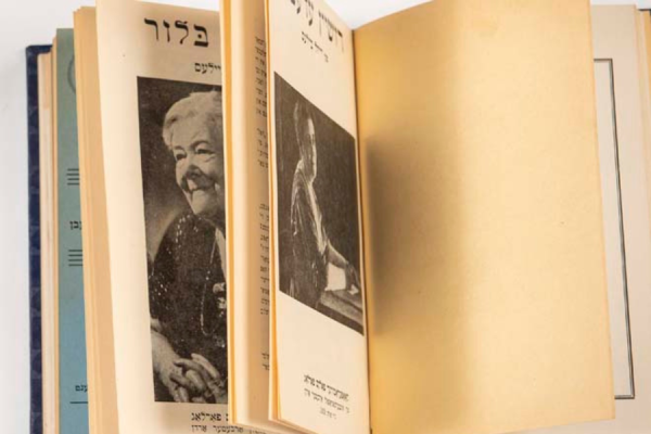 An open book with yellowed pages and photographs of a woman
