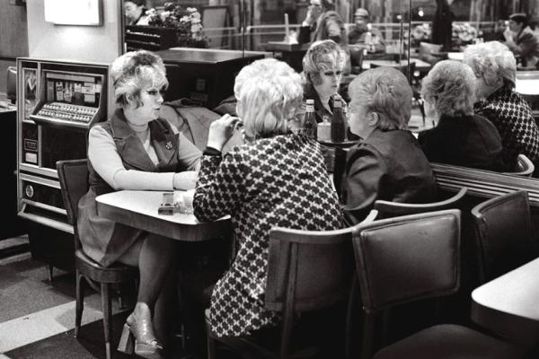 Cover of photography book Kibbitz and Nosh. Women talking at a diner. 