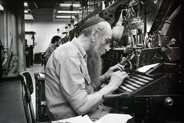 Black and white photo of typesetter at forward. 